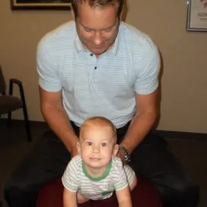 Chiropractor Naperville IL Timothy Erickson adjusting infant